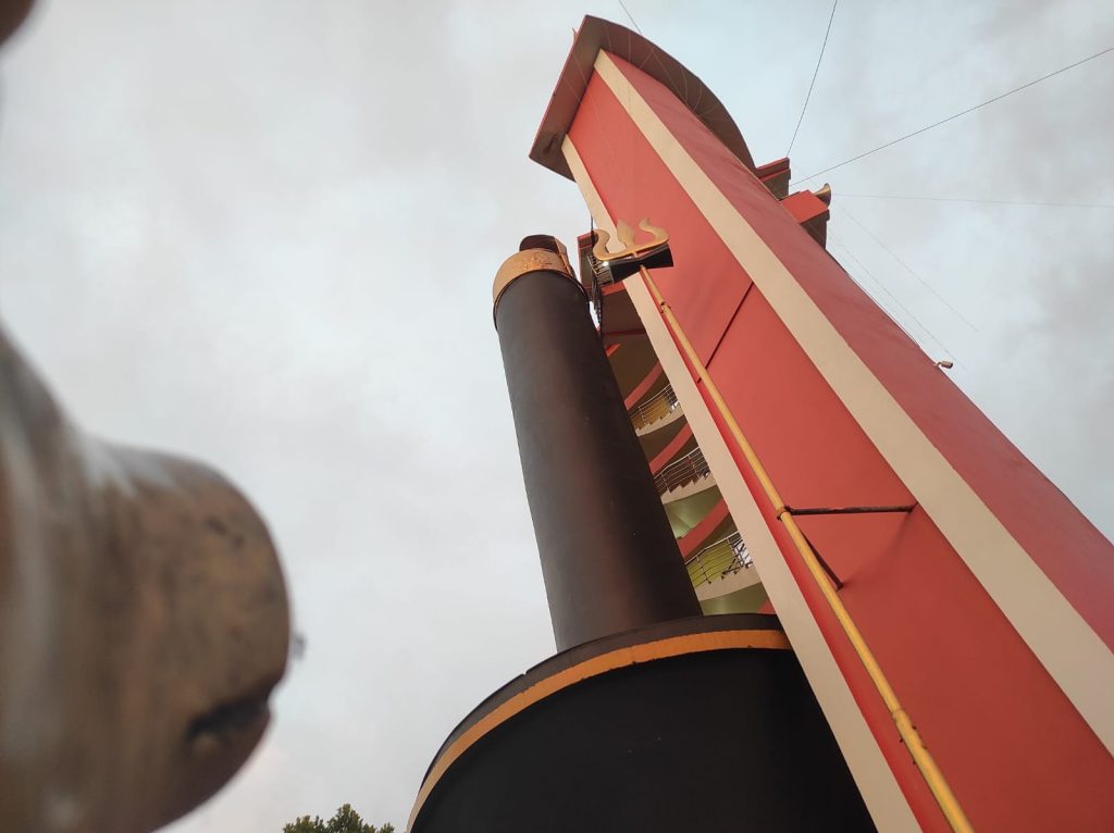 Alt Text: The sacred bull statue in front of the Shiva Linga, with nearby shrines and temples in view.